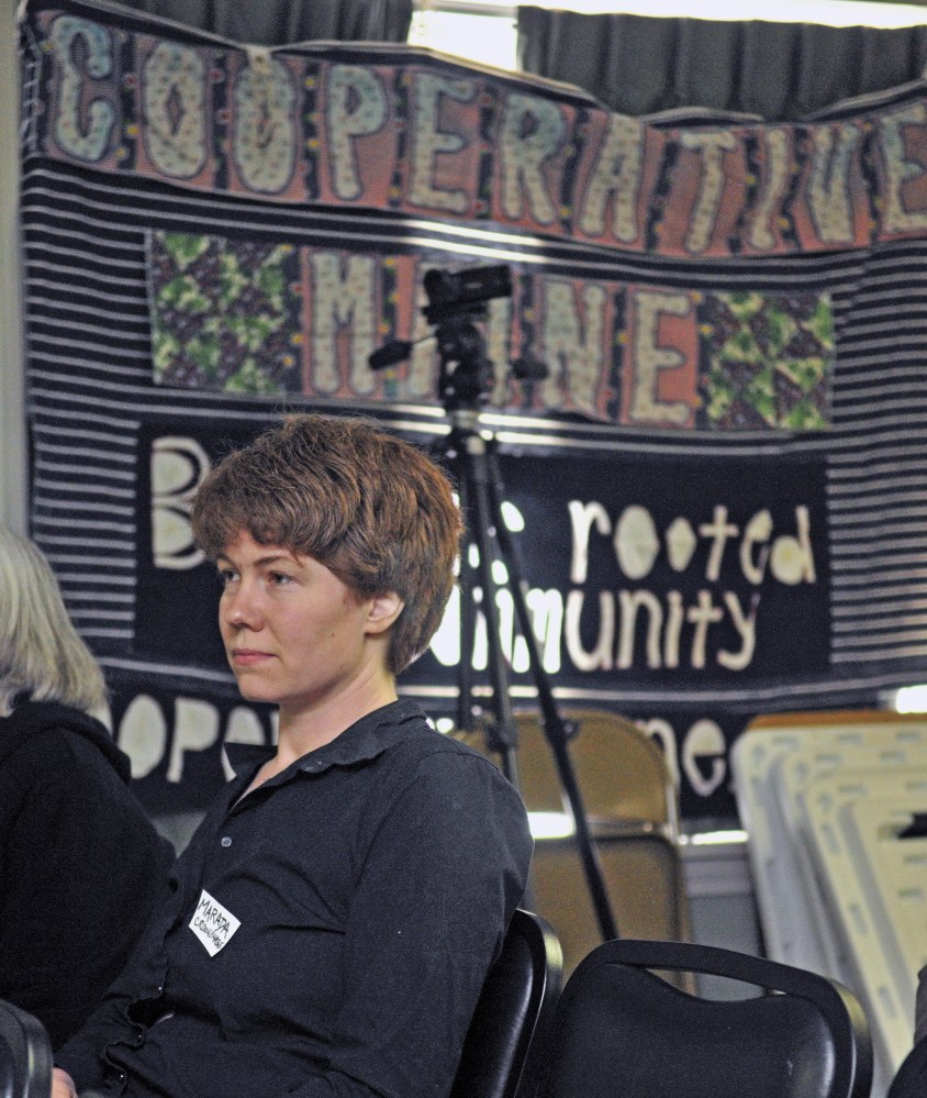 Marada Cook, of Crown O’Maine, listens to a panel discussion during a conference on business cooperatives Saturday at the Viles Arboretum in Augusta.